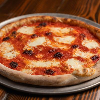 The Wendy Pizza with red sauce, burrata, nduja, basil and honey.