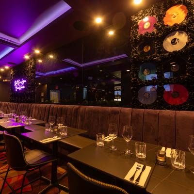 Interior, seating room, banquette with tables and chairs, tableware, wall decorations.