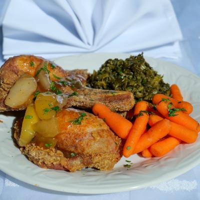 Fried porkchops with sides, closeup.