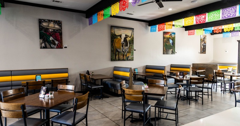 Interior seating area with wooden furniture and booths