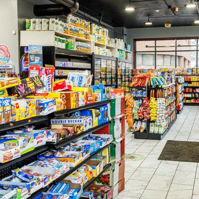 A store interior with aisles of packaged snacks and drinks.