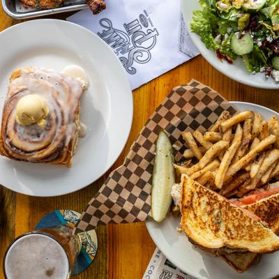 A variety of dishes on a wooden table, top view.