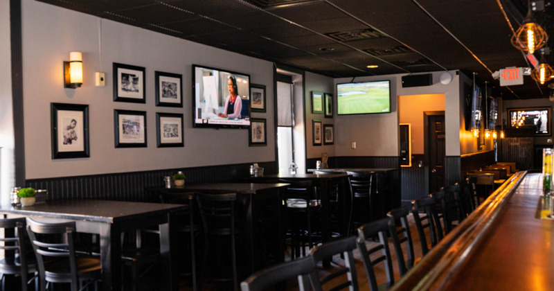Interior - tables next to the wall decorated with pictures