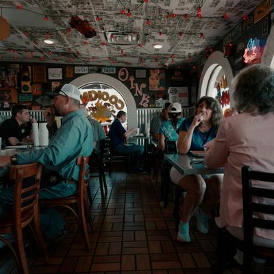 Restaurant's interior and decor with guests seating at tables.