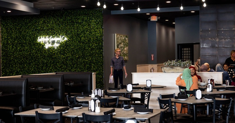 Interior, dining area with tables and flowers as a decoration in foreground