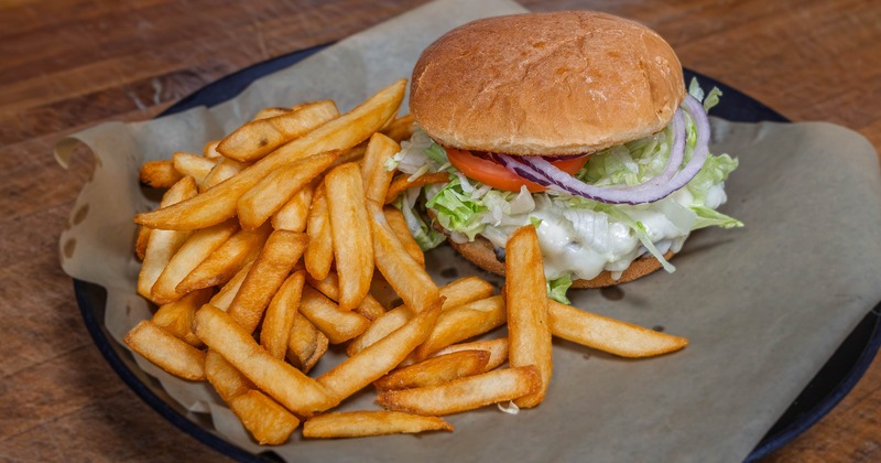 Cheeseburger served with a side of golden French fries