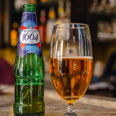 A bottle and glass of Kronenbourg beer.