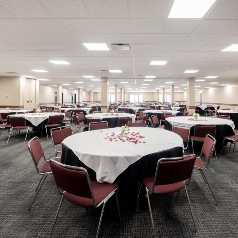 A large dining hall with lots of tables and chairs.