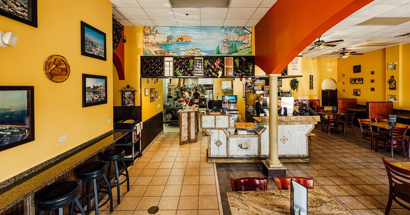 Onterior, diner area, tables, chairs, food and drink counter behind