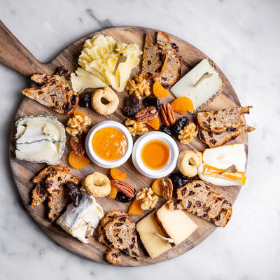 A top view of a platter with various types of cheese on it