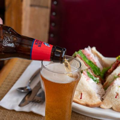 Beer being poured from a bottle into a glass.