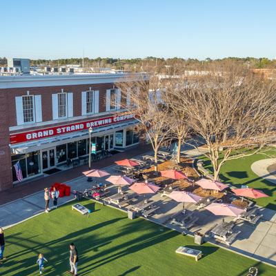 Aerial view of the Grand Strand Brewing Company and its outdoor seating area.