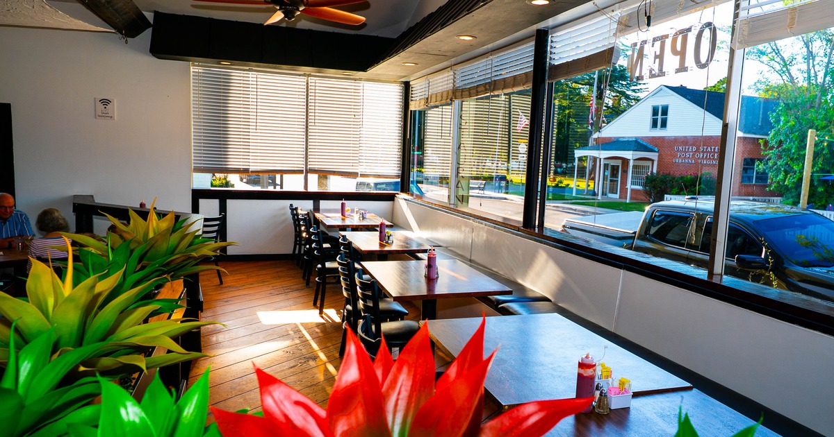 Interior, dining area, long banquette bench with tables and chairs, large windows