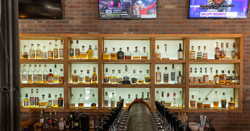 Interior, bar shelves with different bottled drinks