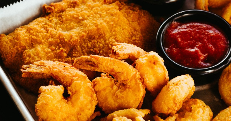 Appetizer platter with fried seafood and sauces