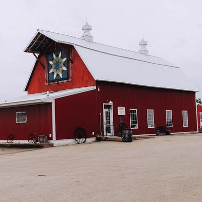 Next Chapter Winery, wedding venue, red barn with white roof and star quilt pattern.