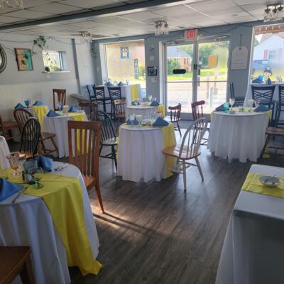 Dining area featuring round two-top tables set for service.
