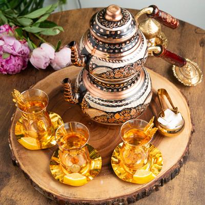 Tea pot and filled cups.