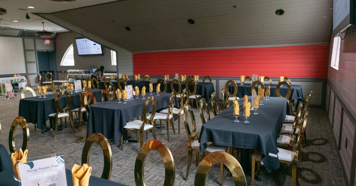 Interior, seating area, tables with gold painted chairs, ready for guests, slant roof