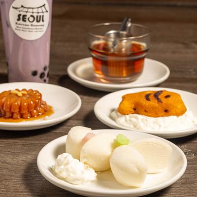 Various desserts served alongside bubble tea and a cup of hot tea.