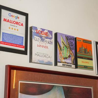 Wall display with awards and framed certificates.