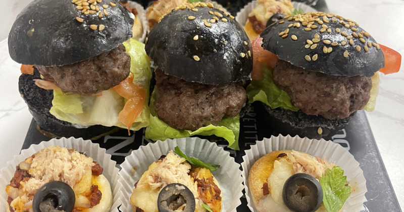 Mini black-bun burgers and savory bite-sized pastries