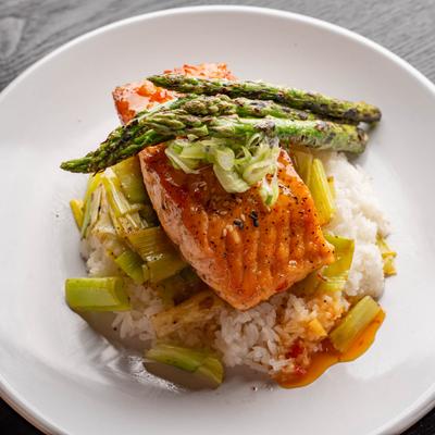 Miso Glazed Salmon served over rice with green onion and asparagus.