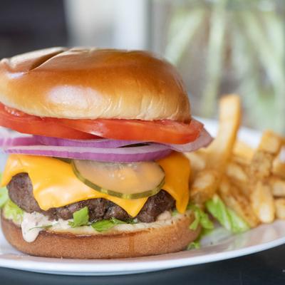 A served cheeseburger with fries.