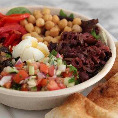 Mediterranean salad with chopped vegetables, hard boiled egg and kalamata olives.