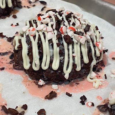 Chocolate brownie, topped with cream and chocolate chips.