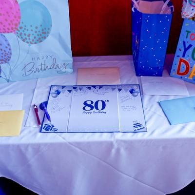 Table setting with party decorations for an 80th birthday celebration.