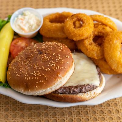 Cheeseburger with lettuce and tomato, served with onion rings, coleslaw, and a pickle spear.