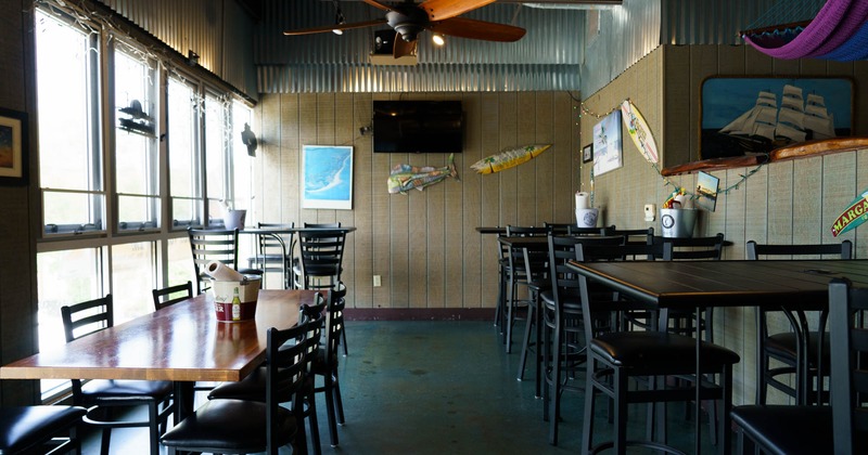 Interior, dining area, high and regular seating tables, ceiling fan, TV on the wall