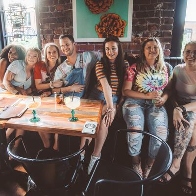 Interior, seated guests, smiling and enjoying drinks