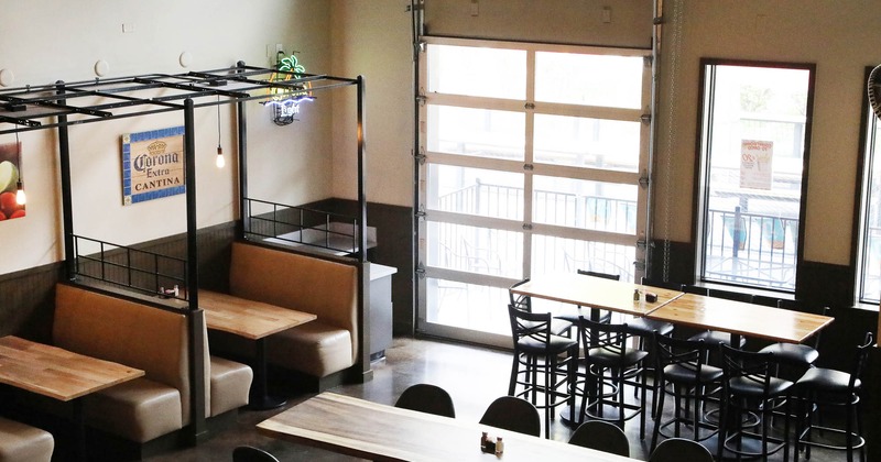 Interior, booths, tables and chairs by the windows