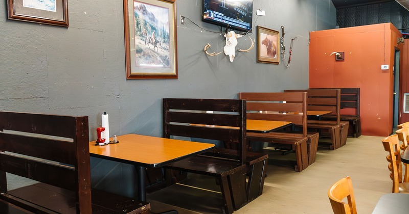 Wooden dining booths lined up along the wall