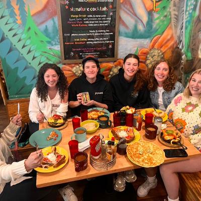 People sitting at a full table.