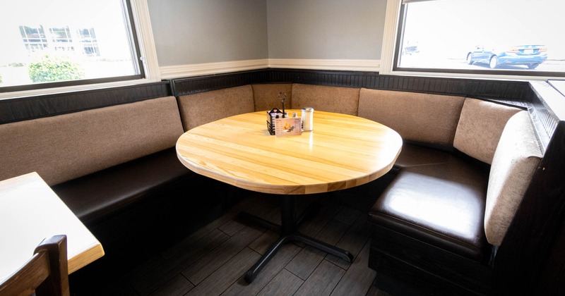 Interior, rounded table in the corner with boots