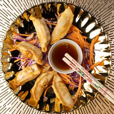 Fried dumplings with dipping sauce.