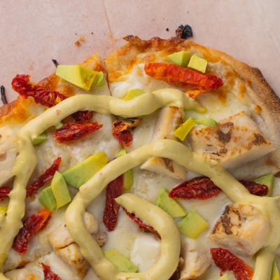 Viola Pizza, with mozzarella, sun dried tomato, grilled chicken, avocado, sauce, and EVOO.