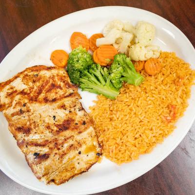 Grilled chicken breast, served with rice, steamed broccoli, carrots, and cauliflower.
