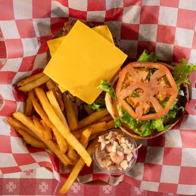 Cheeseburger with cheddar, lettuce, and tomato served with fries.