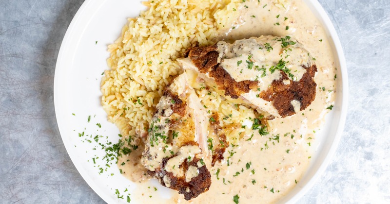 Chicken Cordon Bleu served with mustard cream sauce and rice pilaf