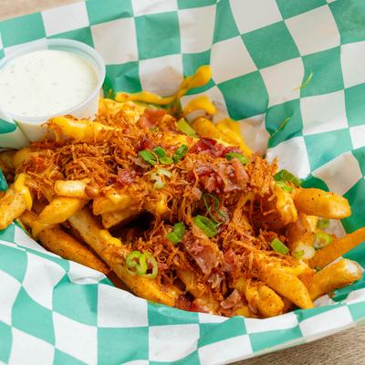 Cajun Cheese Fries with Real Crab Meat served with a creamy white sauce dip.