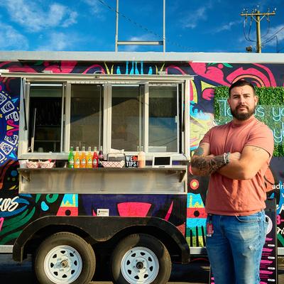 The owner posing by the food truck.