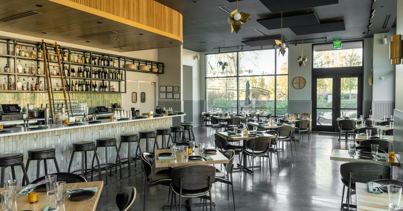Interior, bar and seating area, wooden and black accents, large windows