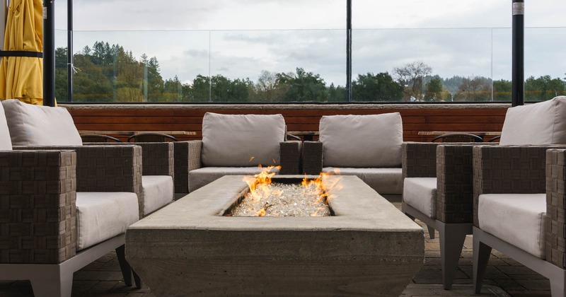 Sofas with grey cushion around a fireplace