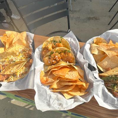 Various tacos and tortilla chips.