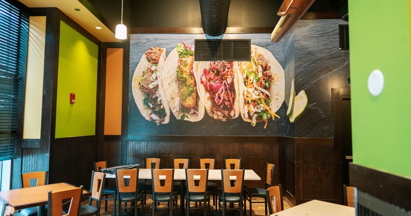 Inside, long dining table, chairs, wallpaper