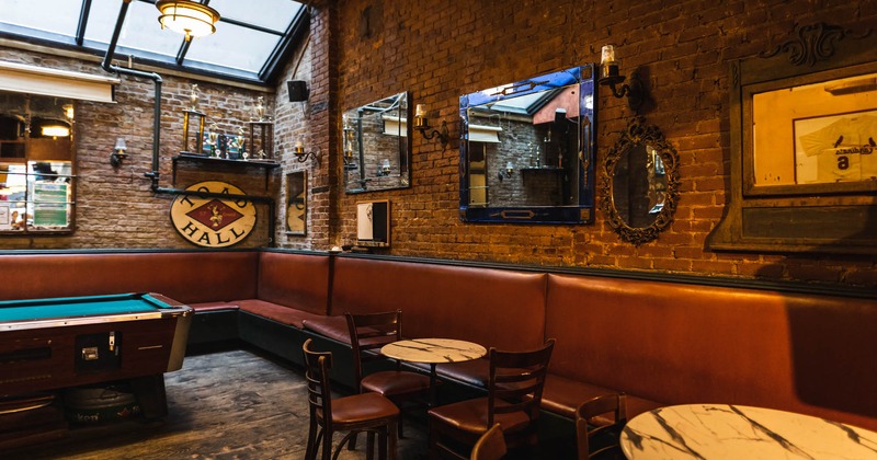 Inside, brick wall, decoration, long leather banquette seating, dining table and chairs